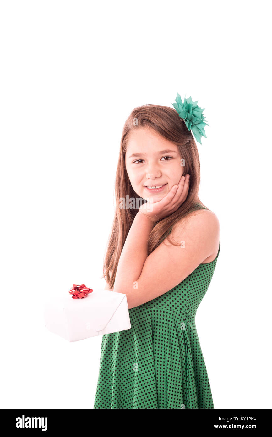 Portrait of happy little girl holding at back a gift box over white ...
