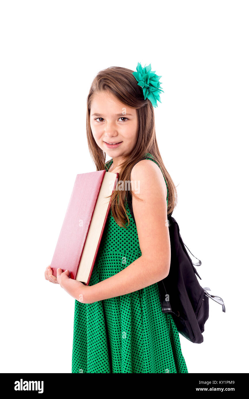 Portrait of a pretty girl with school backpack holding a book isolated ...