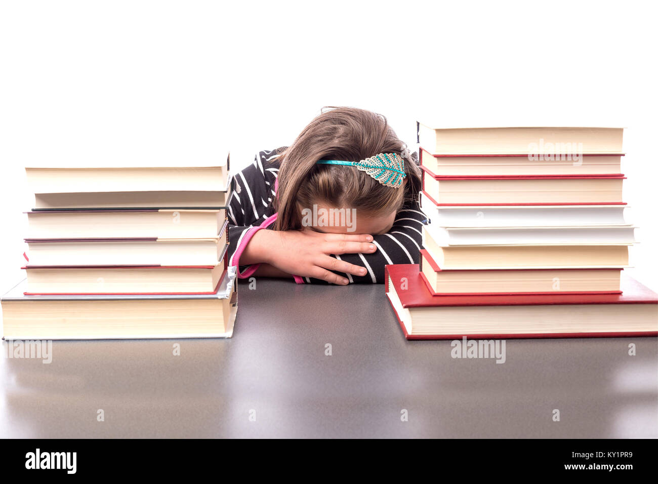 School girl sleeping on a stack of books over white background Stock ...