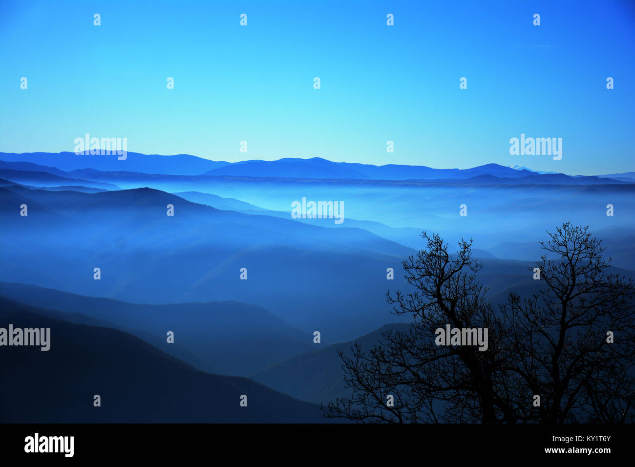 wavy blue mountains and fog Stock Photo