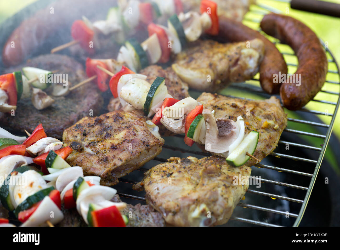barbecue with delicious grilled meat and vegetables on grill Stock ...