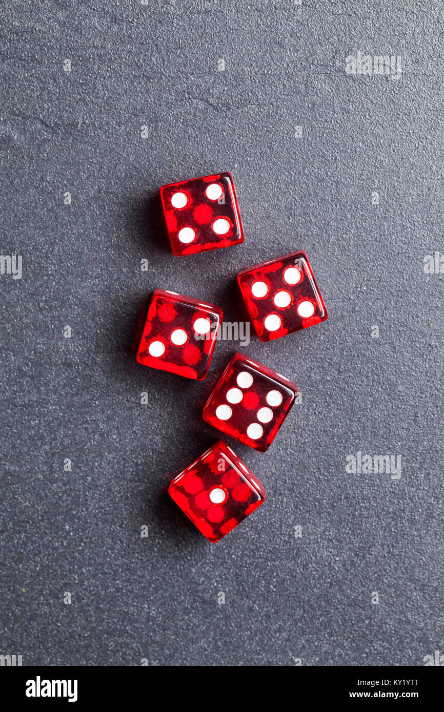 A set of red dice on a slate background. Betting and gambling concept Stock Photo