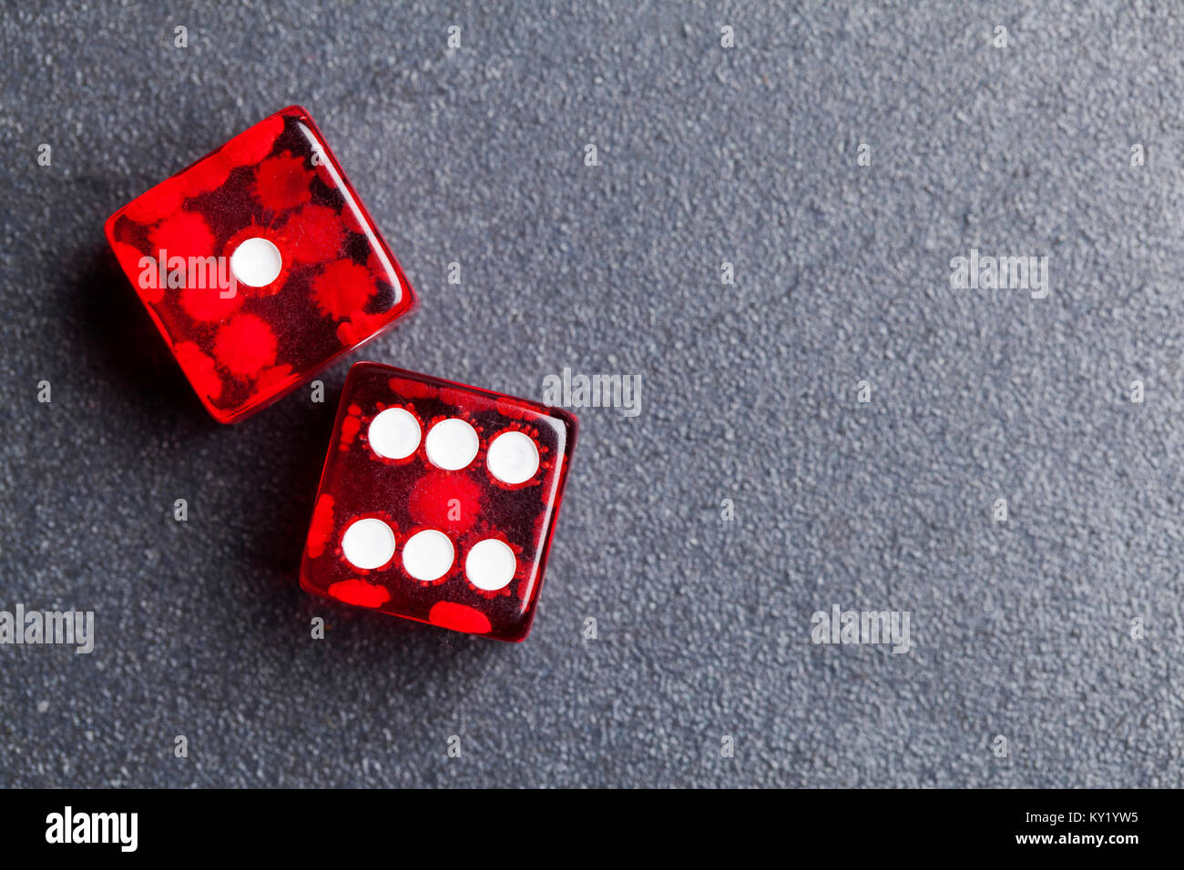 A set of red dice on a slate background. Betting and gambling concept Stock Photo