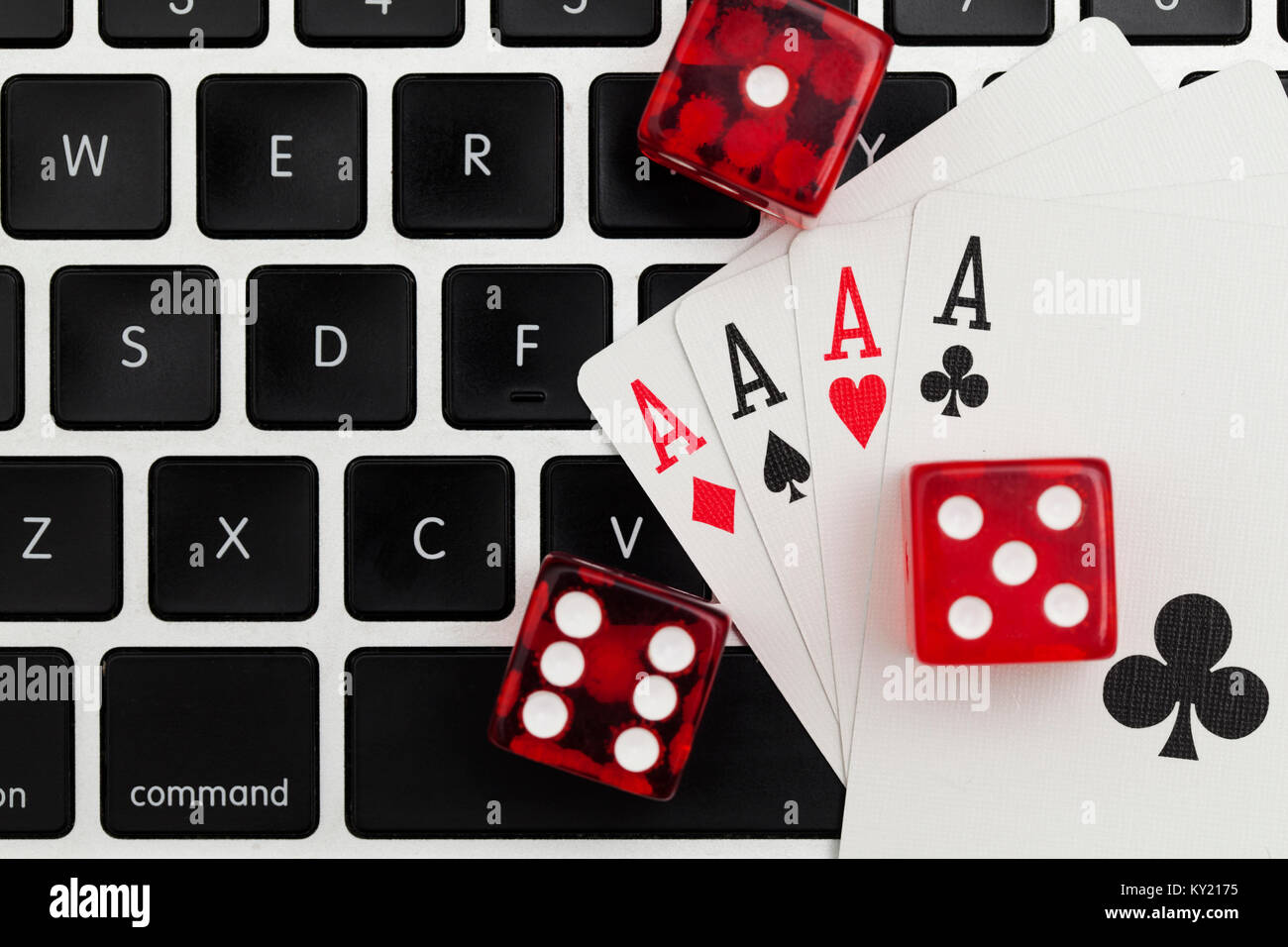 Online gambling. Playing cards and dice on a computer keyboard Stock Photo