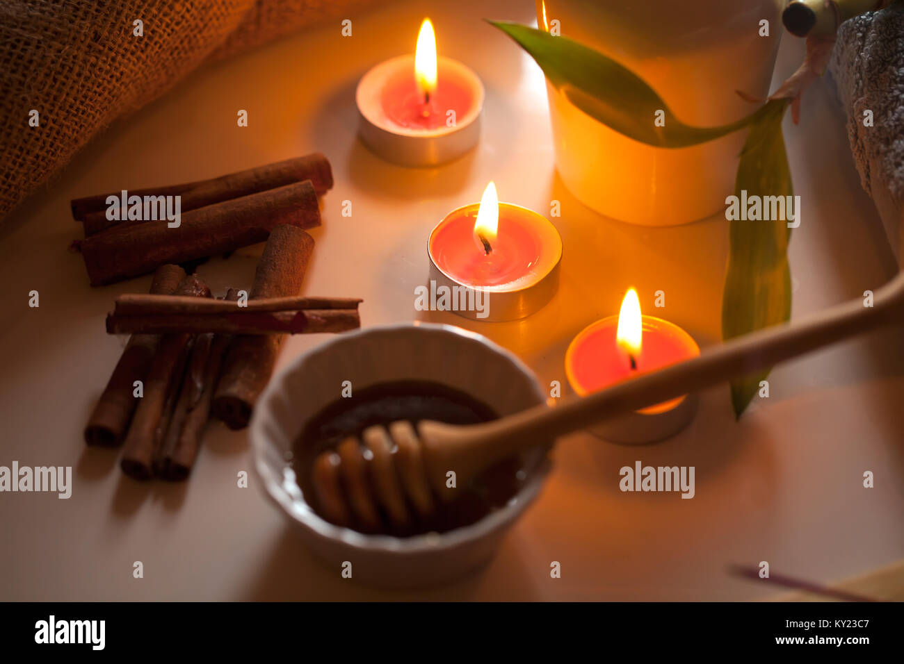 honey and aromatic candles on table,spa and welness concept. Stock Photo