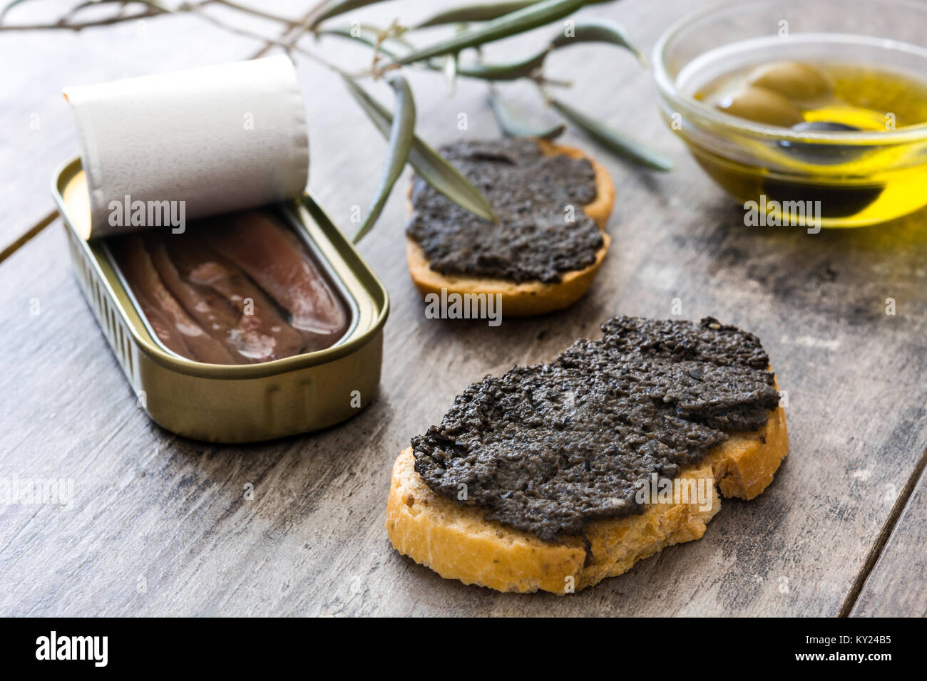 Black olive tapenade with anchovies, garlic and olive oil on wooden