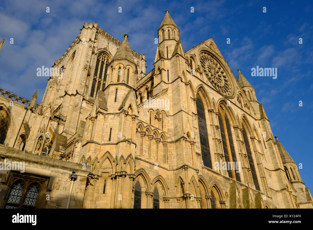 The ornate South Transept elevation of York Minster against a blue sky. Stock Photo