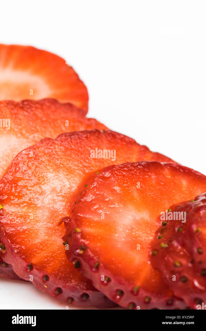 Juicy strawberry slices on white. Showing texture. Stock Photo