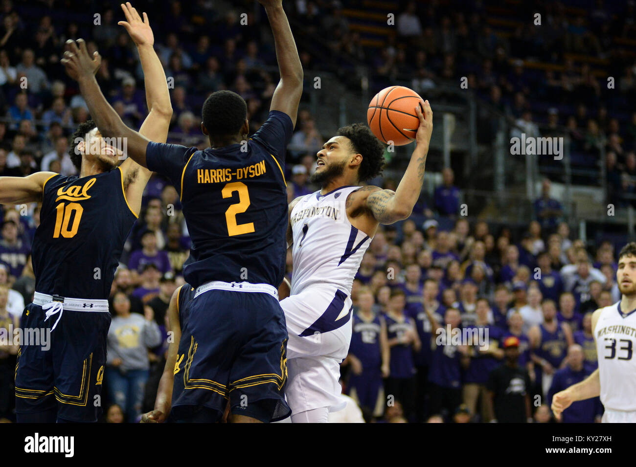 Seattle, WA, USA. 11th Jan, 2018. UW point guard David Crisp (1) drives down the lane against Cal defenders Juhwan Harris-Dyson (2) and Justice Sueing (10) during a PAC12 basketball game between the Washington Huskies and Cal Bears. The game was played at Hec Ed Pavilion in Seattle, WA. Jeff Halstead/CSM/Alamy Live News Stock Photo