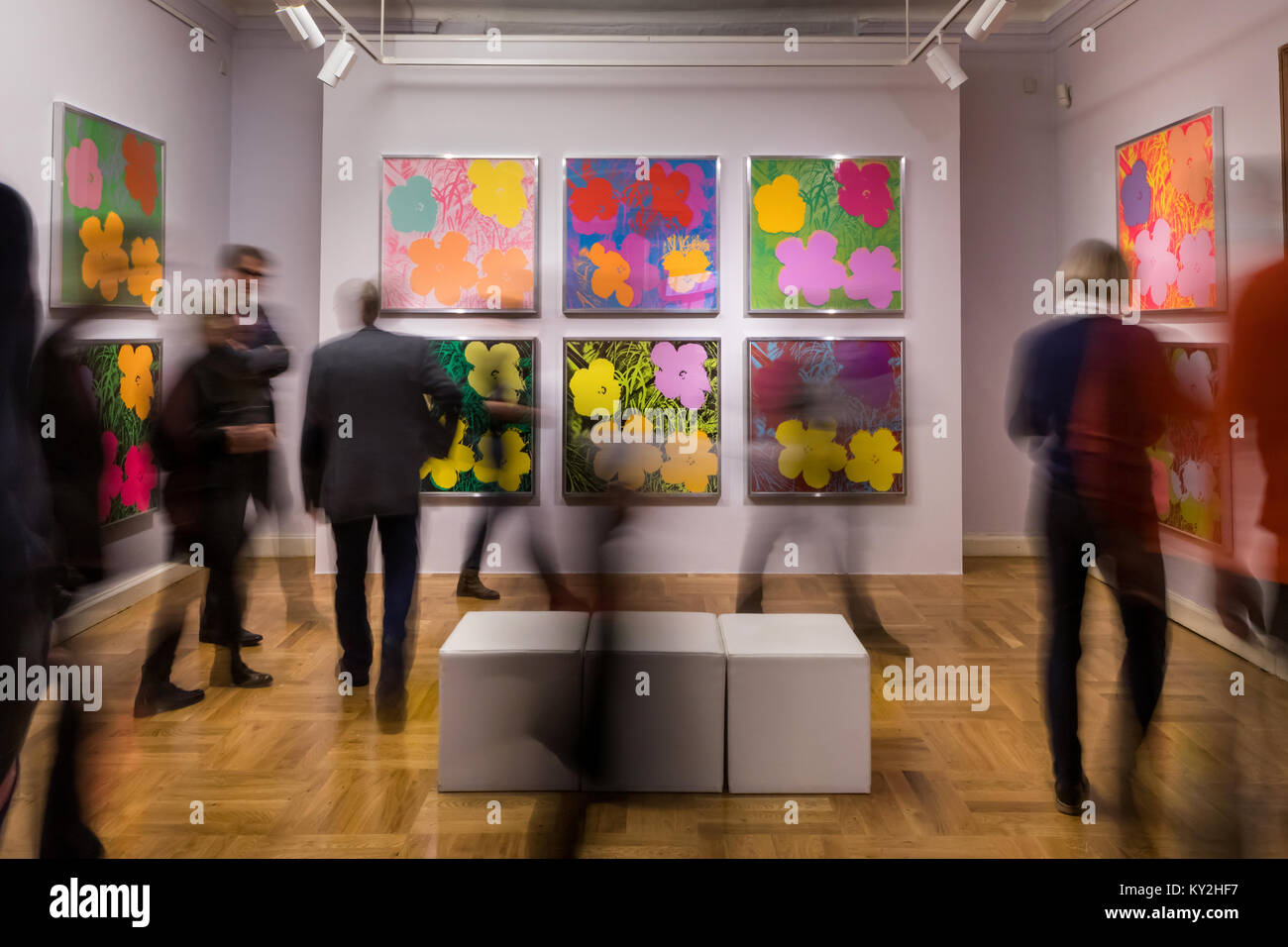 Apolda, Germany. 12th Jan, 2018. Visitors looking at pictures in the 'Andy Warhol - The Original Silkscreens' exhibition at the art gallery in Apolda, Germany, 12 January 2018. About 100 originals from 16 silk screen series, among others, 'Marilyn Monroe', 'Campbell·s Soup Cans', 'Mao', 'Flowers', 'Skulls' and the 'Sunsets' series, are on display from 14 January to 01 July 2018. Credit: Arifoto Ug/Michael Reichel/dpa/Alamy Live News Stock Photo