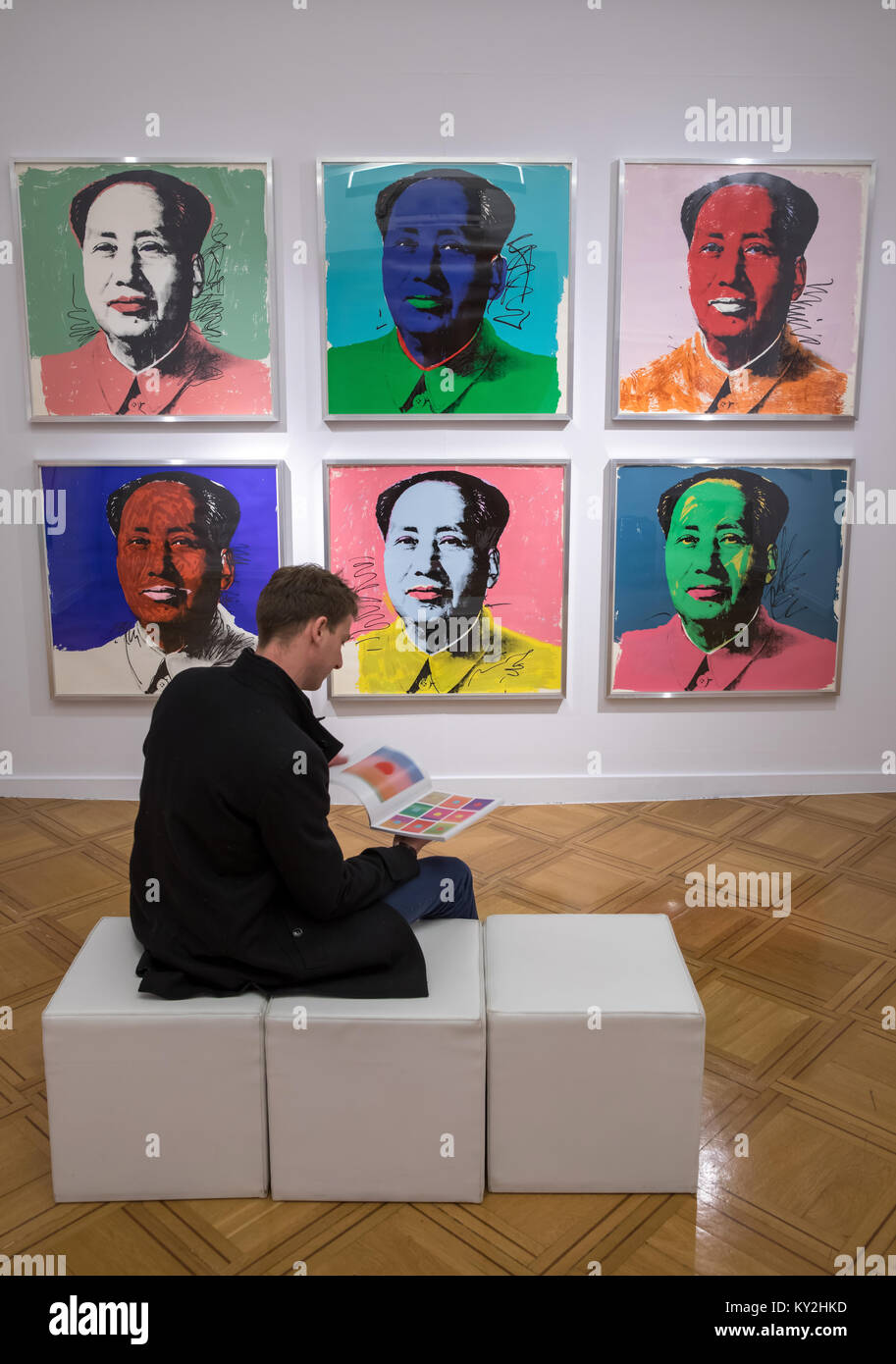 Apolda, Germany. 12th Jan, 2018. A visitor looking at a catalog in the 'Andy Warhol - The Original Silkscreens' exhibition at the art gallery in Apolda, Germany, 12 January 2018. About 100 originals from 16 silk screen series, among others, 'Marilyn Monroe', 'Campbell·s Soup Cans', 'Mao', 'Flowers', 'Skulls' and the 'Sunsets' series, are on display from 14 January to 01 July 2018. Credit: Arifoto Ug/Michael Reichel/dpa/Alamy Live News Stock Photo