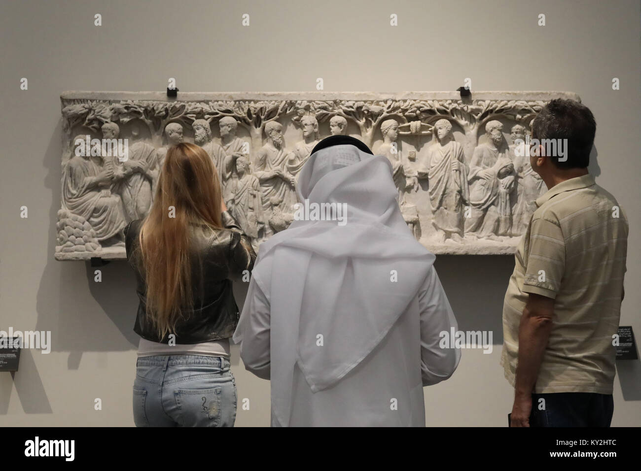 Abu Dhabi, UAE. 12th January, 2018. Visitors examine the displays in the Louvre Abu Dhabi in the UAE capital on 12 January 2018. The museum opened on Saadiyat Island in November 2017, with a collection based on items held by the Louvre in Paris, France. The building was designed by Jean Nouvel. Credit: Dominic Dudley/Alamy Live News Stock Photo