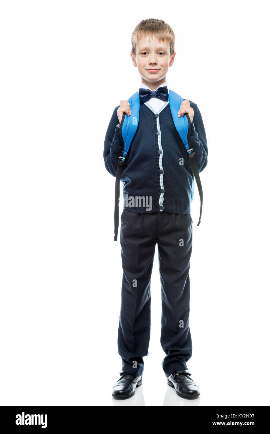 vertical portrait of a schoolboy with a backpack in the form in full ...