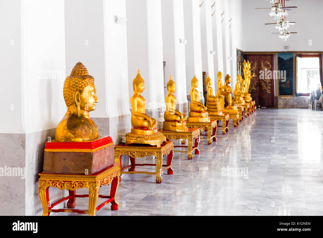 golden statues of Buddha in a bright temple in Bangkok, Thailand Stock ...