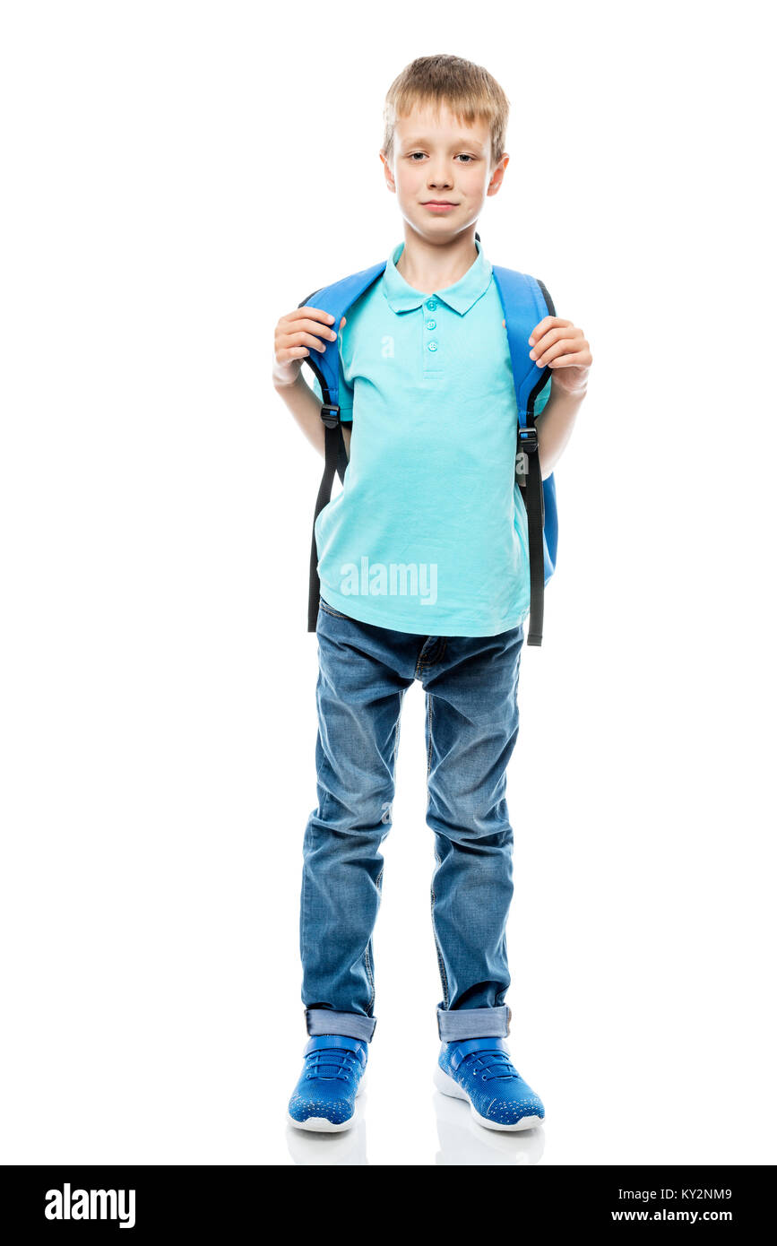 schoolboy 8 years old in a T-shirt and jeans on a white background in full length Stock Photo