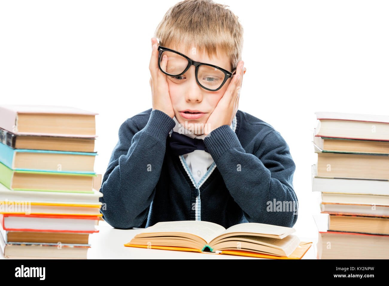 discouraged schoolboy among a pile of books on a white background Stock Photo