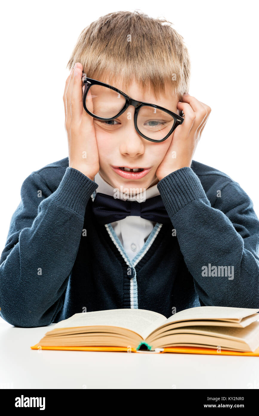 upset schoolboy with a book on a white background Stock Photo