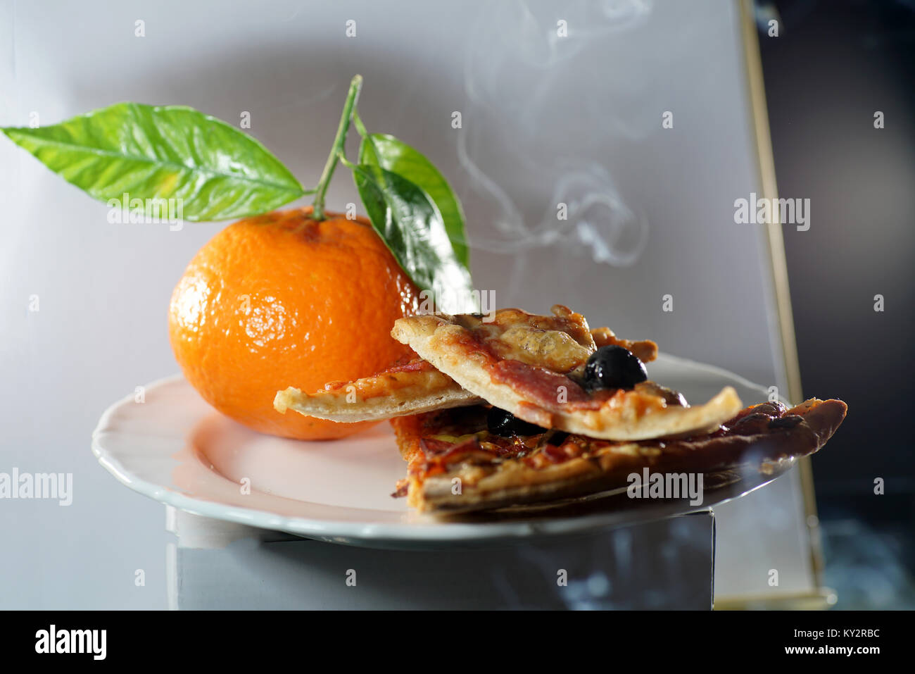 Pizza cuts with anchovies and black olives and salami Stock Photo Alamy