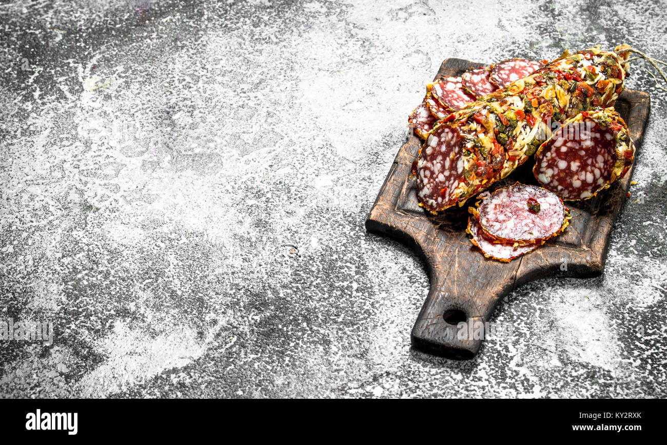 Salami with spices and herbs. On a rustic background Stock Photo - Alamy