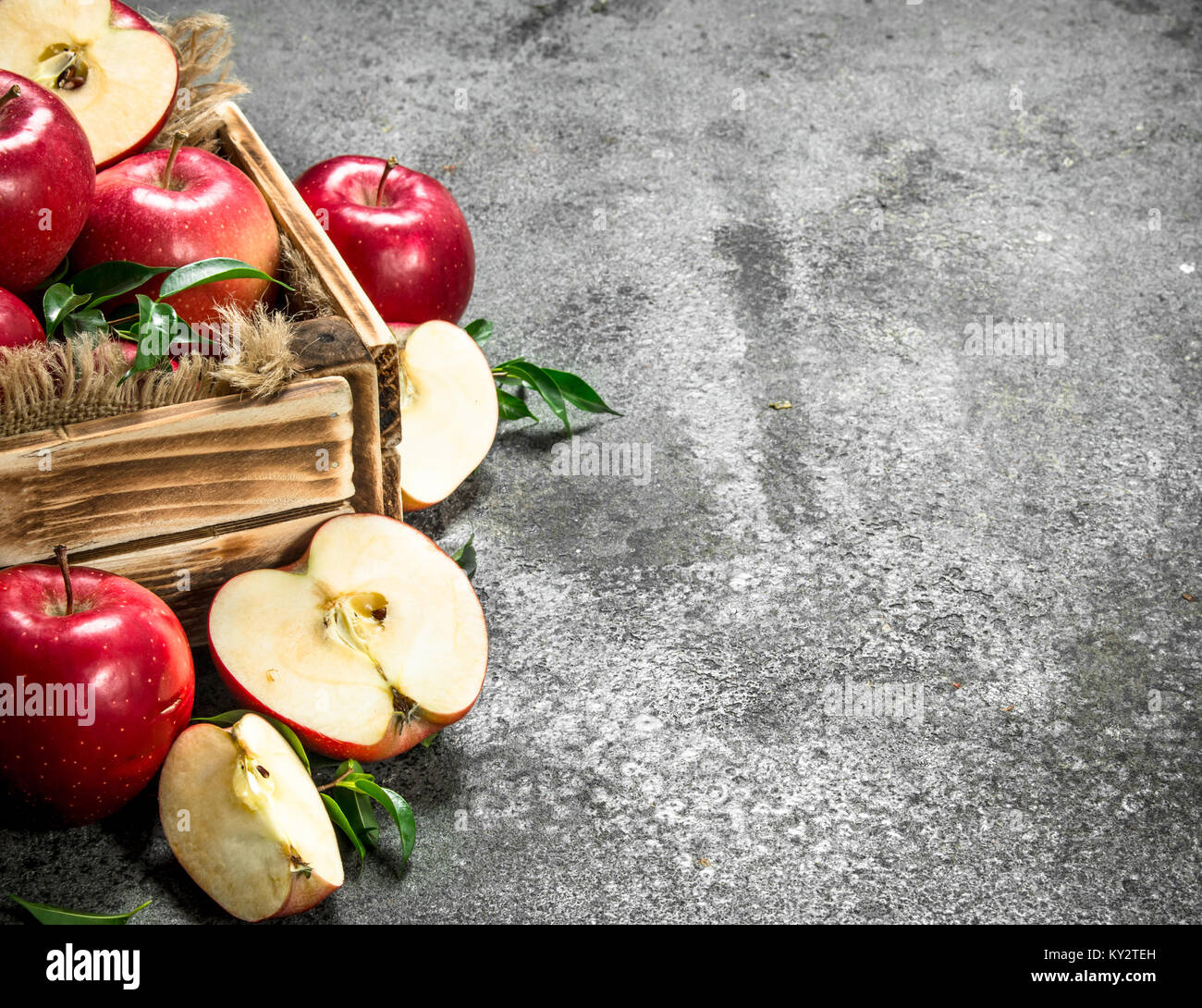 box with ripe red apples. On a rustic background Stock Photo - Alamy