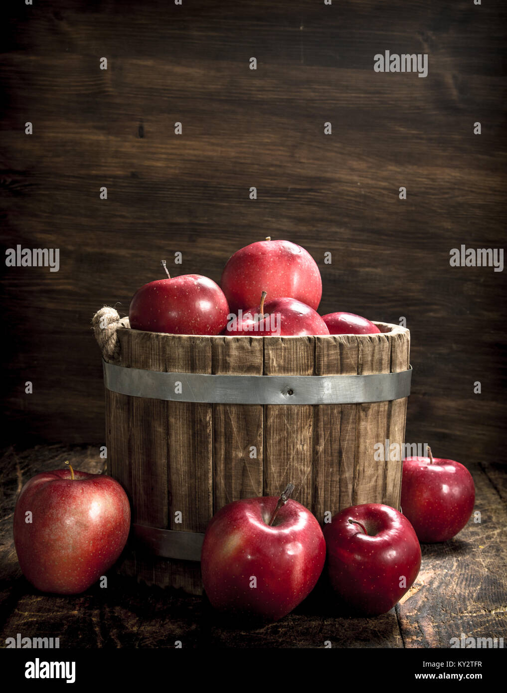 Red ripe apples in a wooden bucket. On a wooden background Stock Photo ...