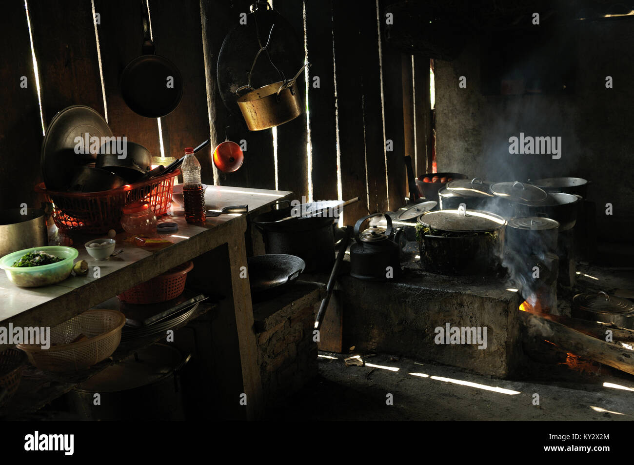 Cooking pots and pans on the fire in a restaurant kitchen, Ba Be National Park, Vietnam Stock Photo