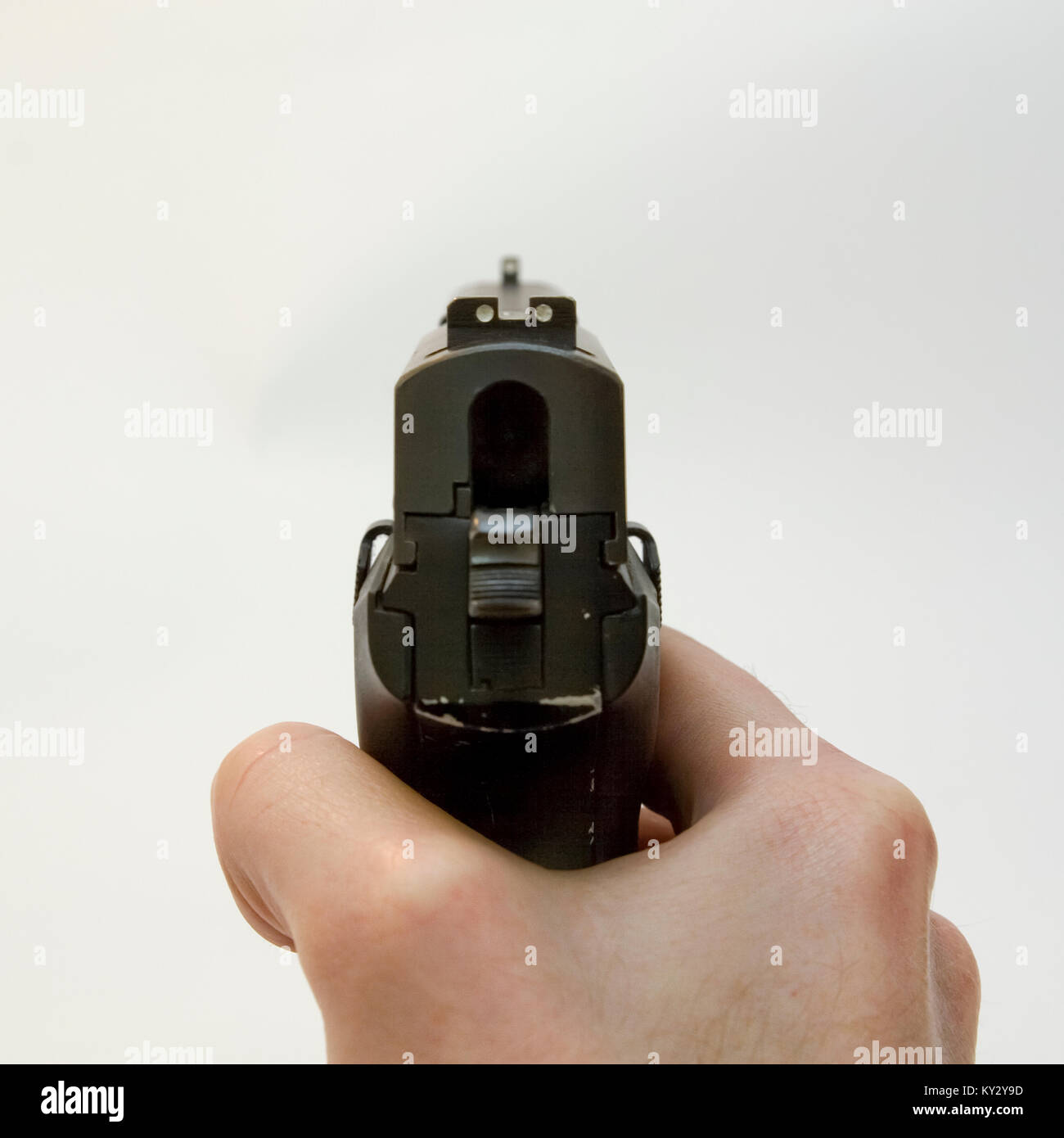 back view of a male hand holding a Czech CZ-99 9mm parabelum semi-automatic hand gun Cut out on white background. first shooter experience Stock Photo