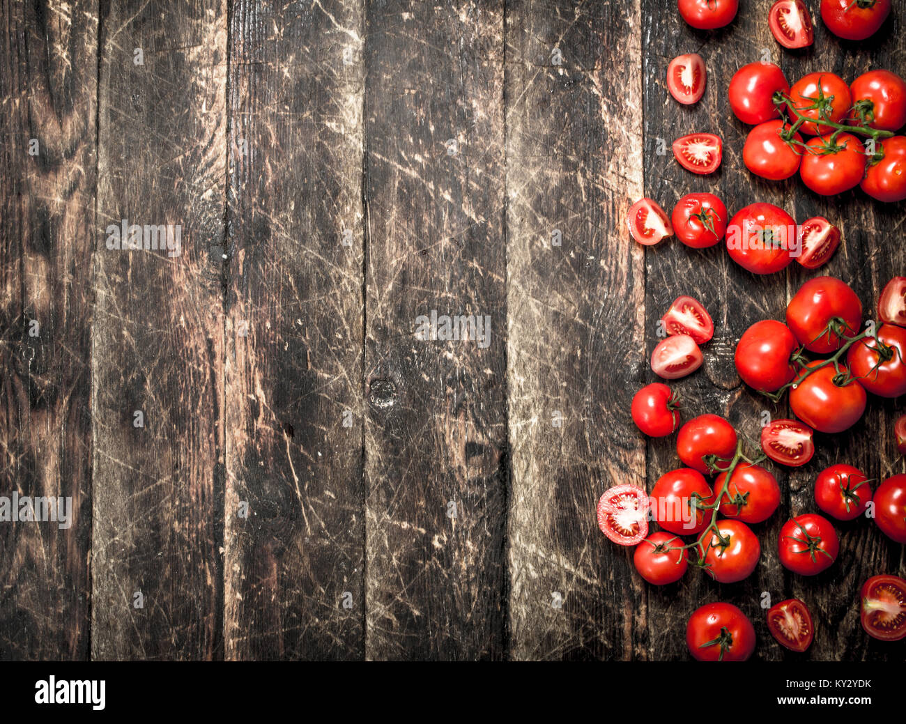 Fresh ripe tomatoes. On the wooden background Stock Photo - Alamy