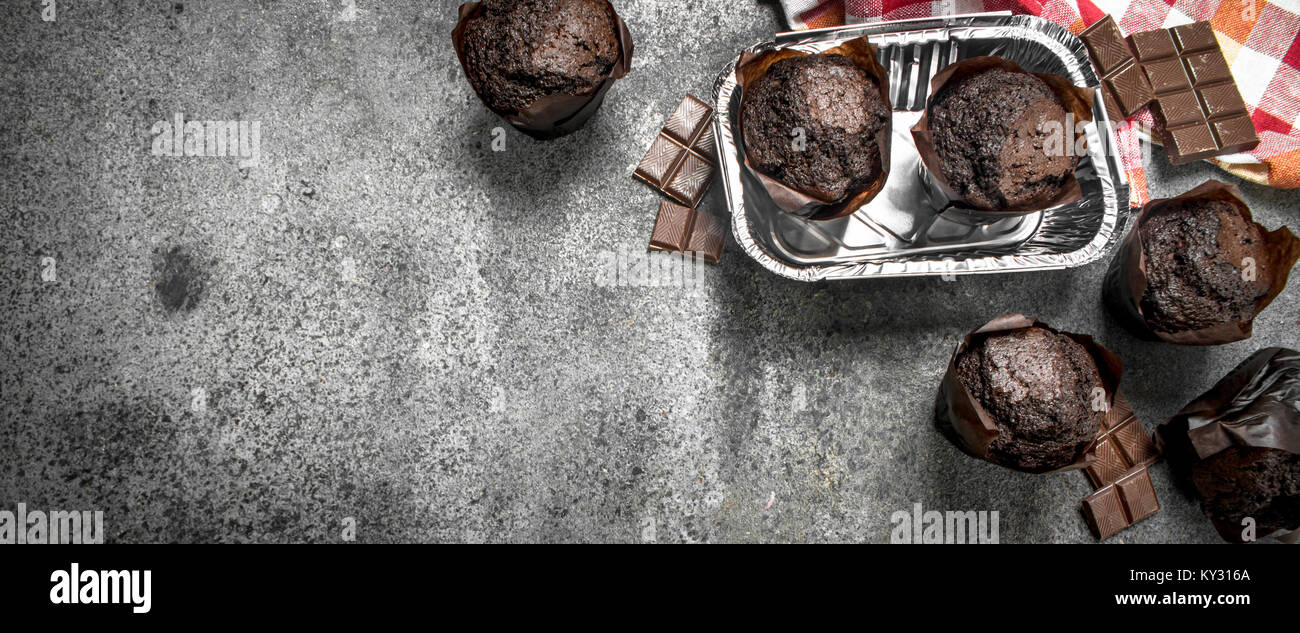 Chocolate muffins with chocolate segments. On a rustic background Stock ...