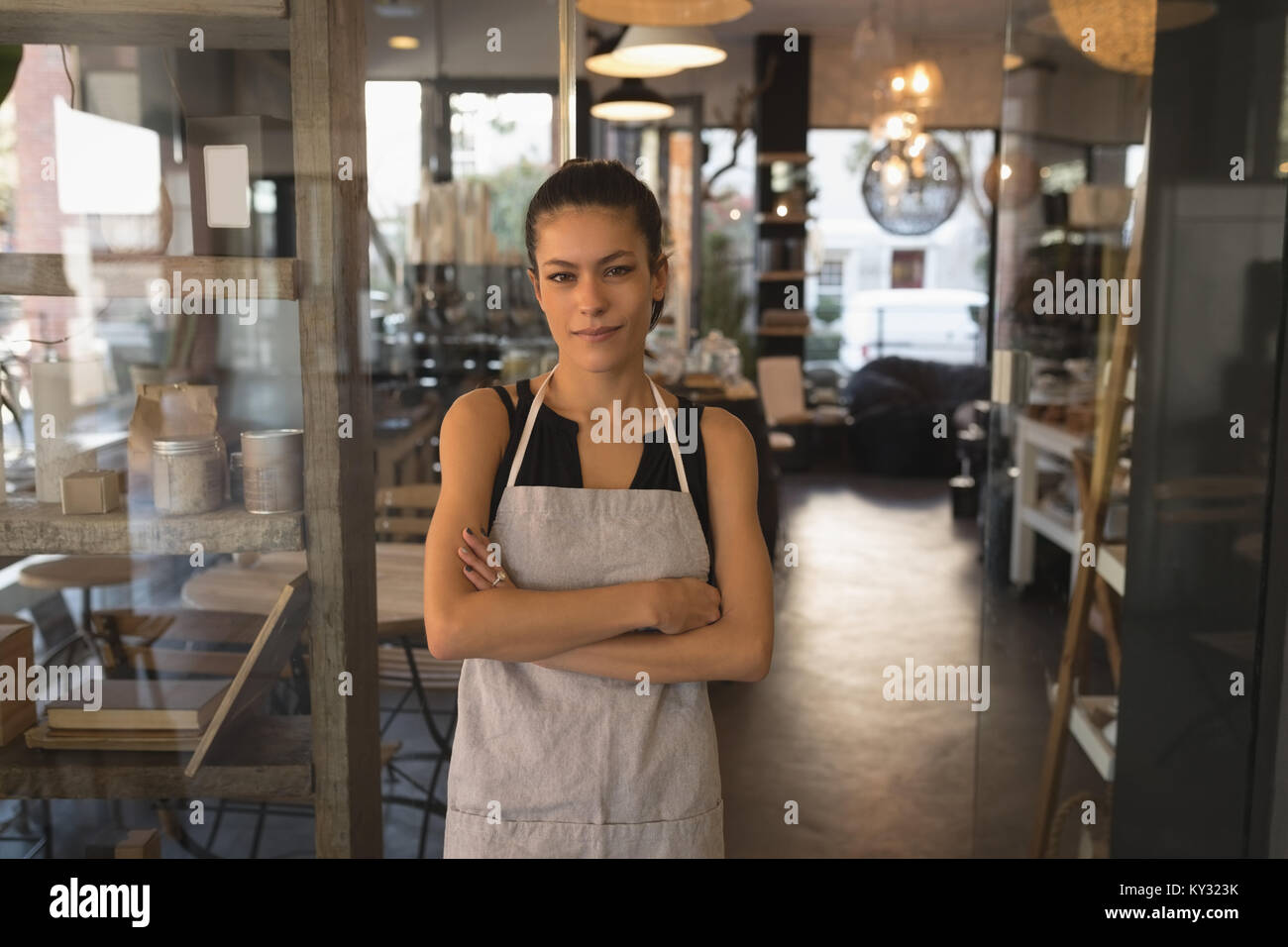 Smiling waitress standing arms crossed hi-res stock photography and ...