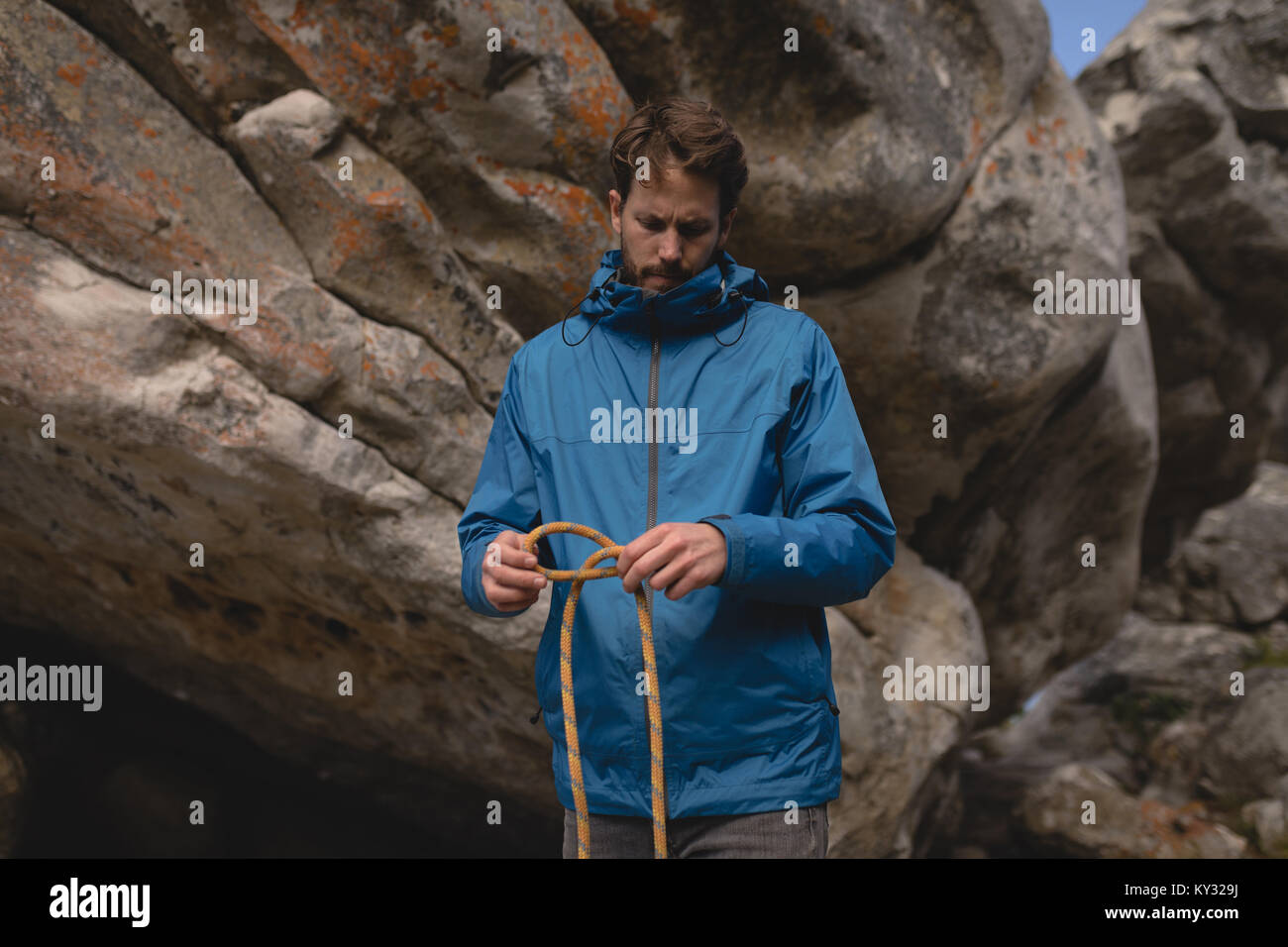 Hiker folding climbing rope Stock Photo Alamy