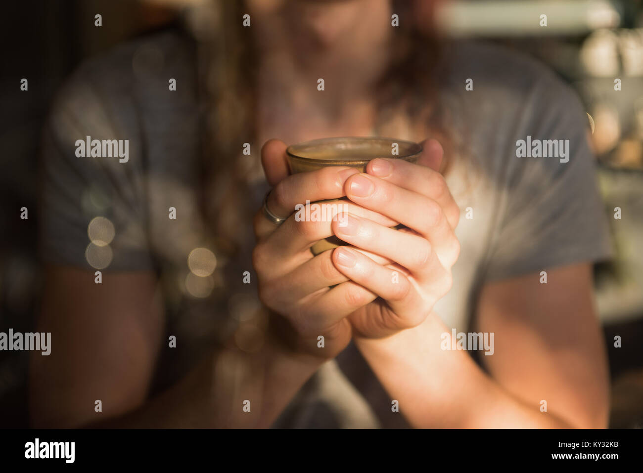 Mid section of man holding a glass of coffee Stock Photo