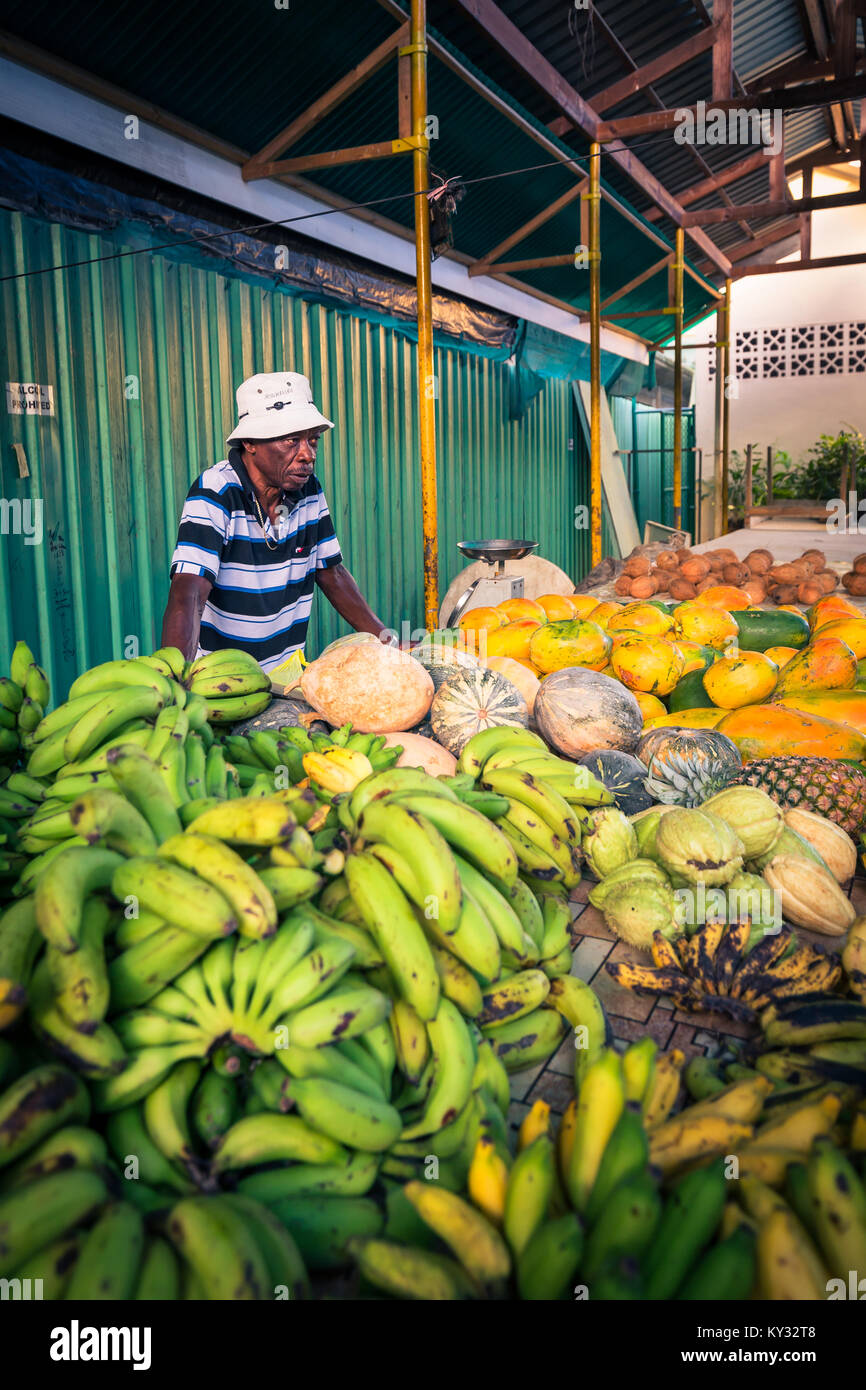 African man selling fruit on market, Victoria, Seychelles Stock Photo