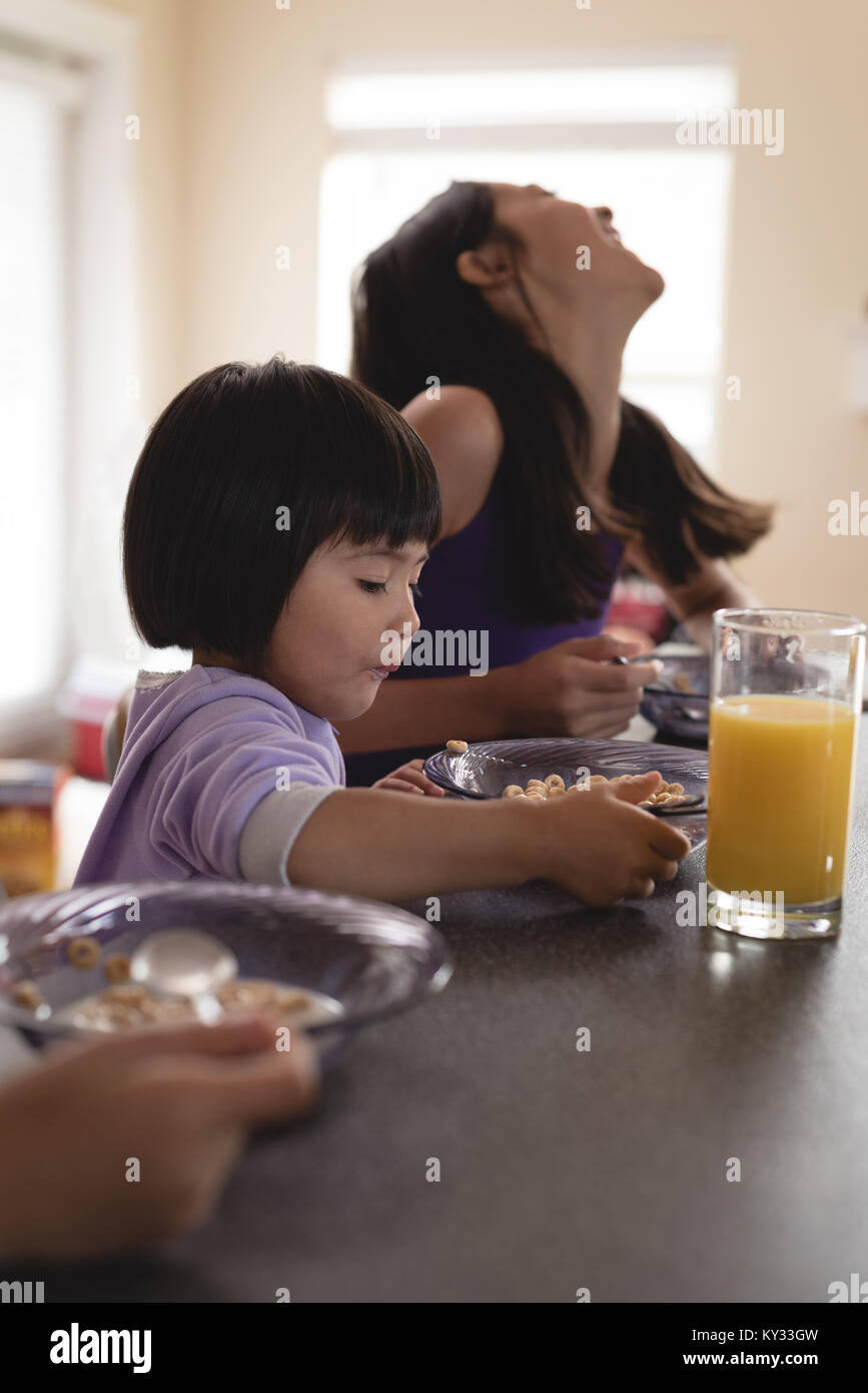 Siblings having breakfast at table Stock Photo - Alamy
