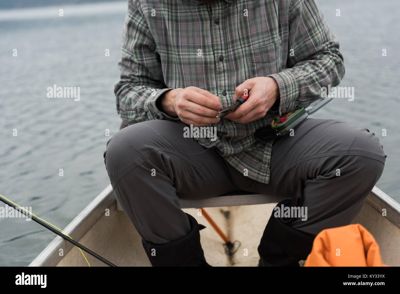 Man holding pliers in his hand at boat Stock Photo