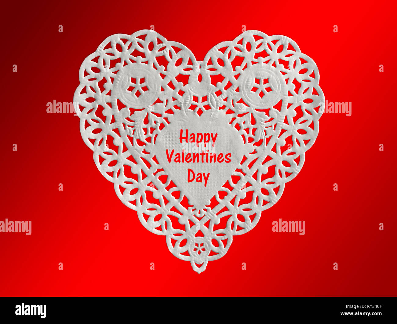 Valentine card, white heart lacy paper  isolated on red background Stock Photo