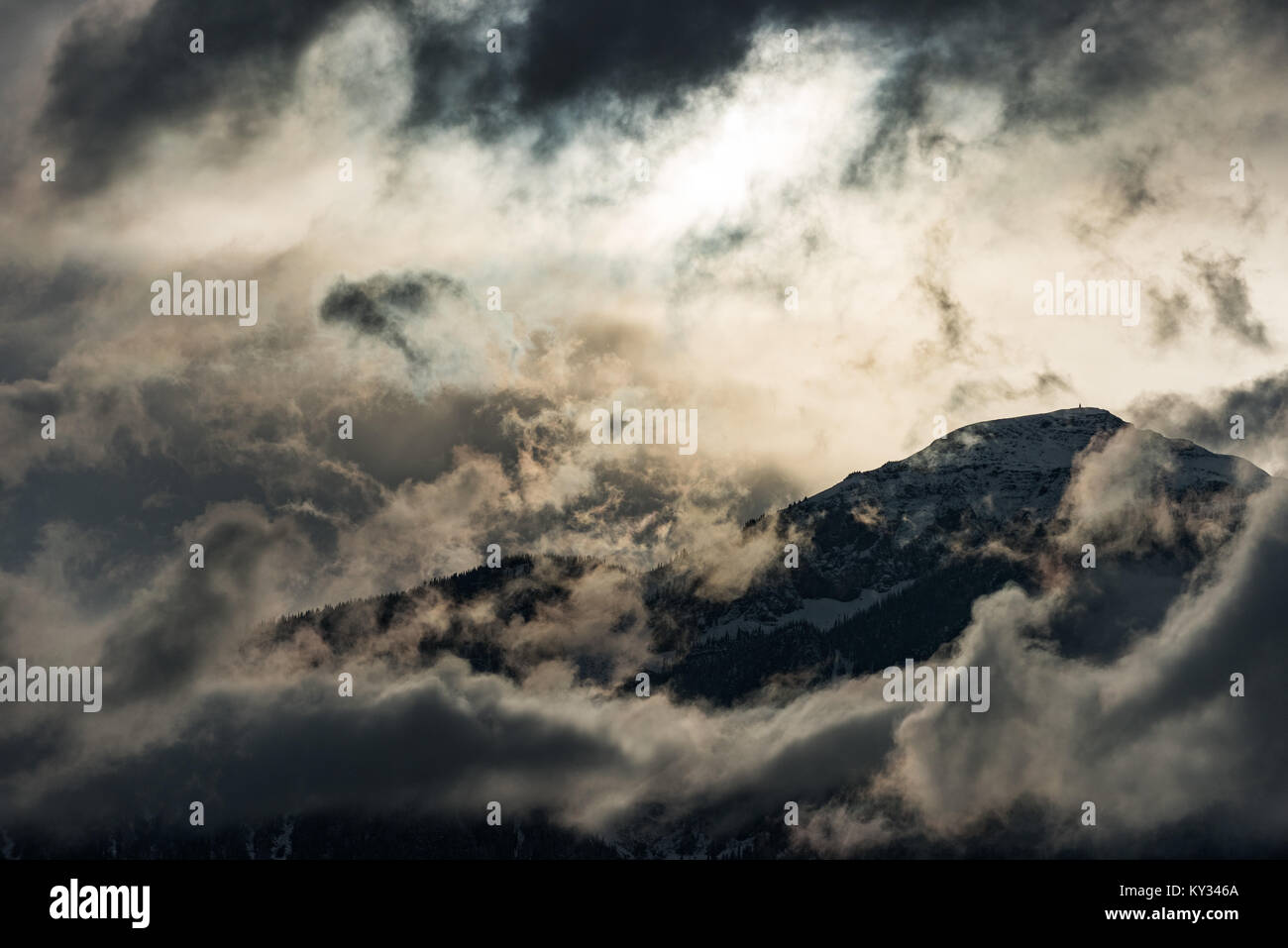 Mountain top surrounded with clouds Stock Photo - Alamy