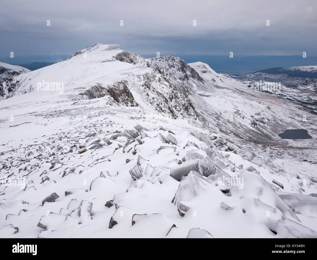 View to Penygadair, the summit of Cadair Idris, from Mynydd Moel under winter conditions. Snowdonia National Park, North Wales. Stock Photo