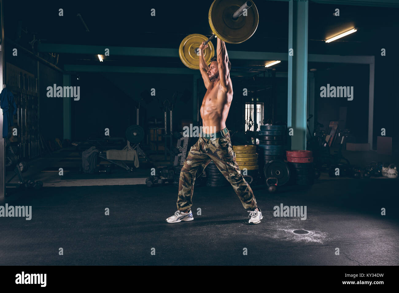 Muscular man exercising with barbell Stock Photo