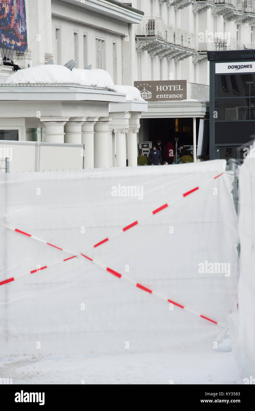 The grand hotel Belvedere in Davos, Switzerland, is shielded from the public by roadblocks and screens during the World Economic Forum (WEF) on January 25, 2013. Every year, massive security precautions for the WEF turn the little Swiss alpine village of Davos into a fortress. Stock Photo