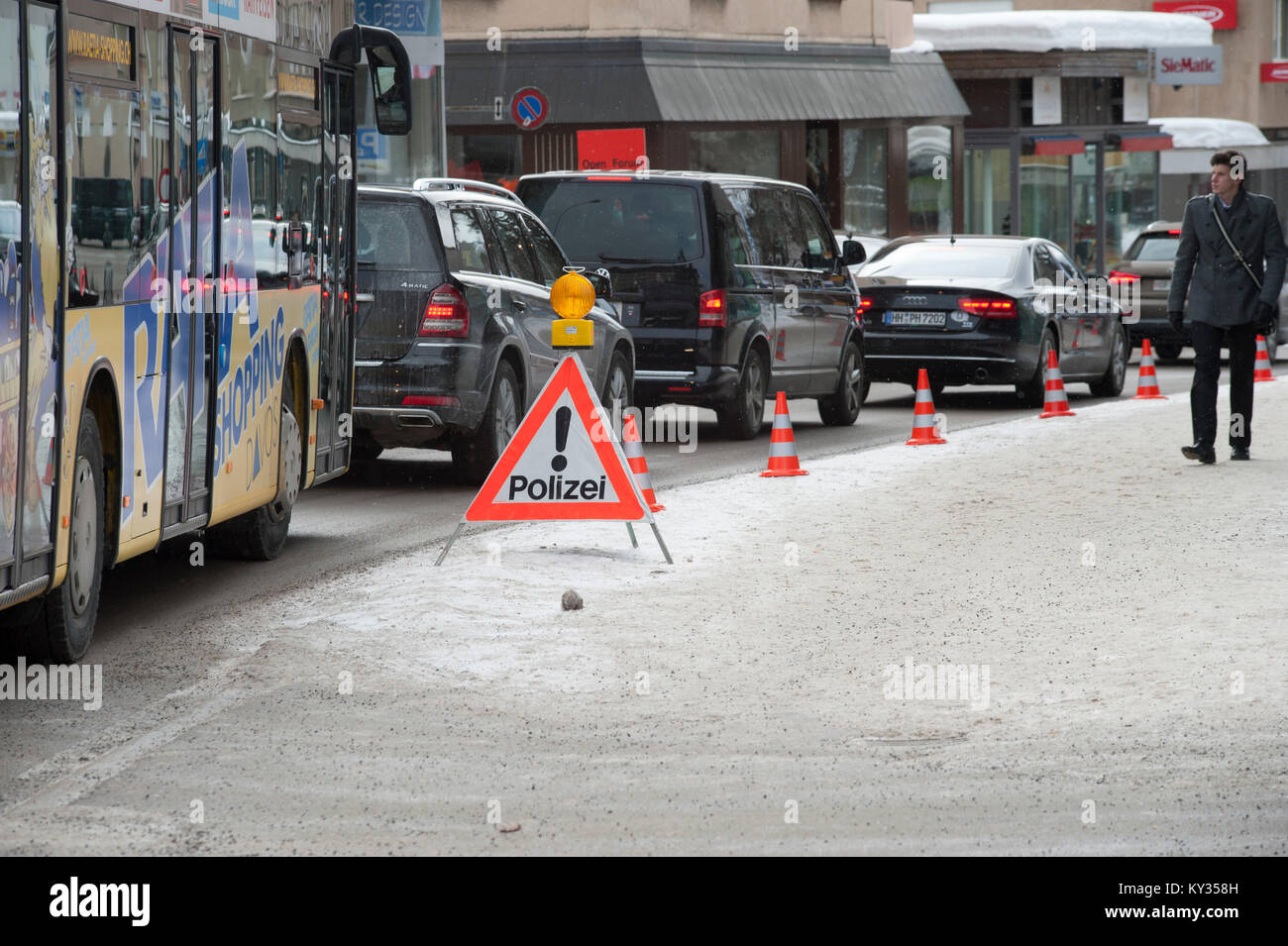 Traffic jam on a police checkpoint in the middle of the little Swiss tourist village Davos during the World Economic Forum (WEF) on January 25, 2013. Every year, massive security precautions for the WEF turn the little Swiss alpine village of Davos into a fortress. Stock Photo