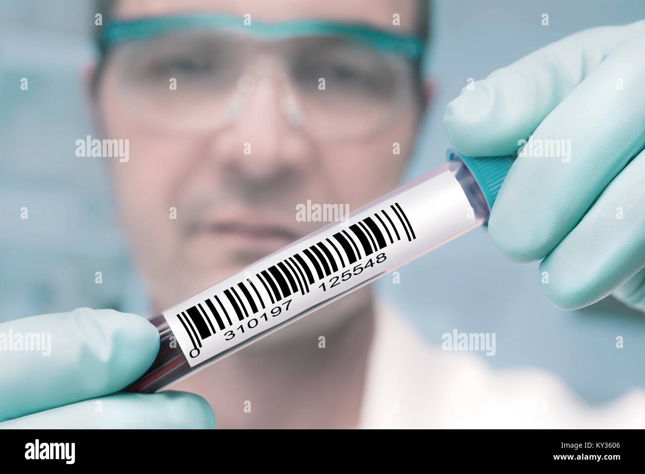 Tech with a medical sample labeled with a barcode Stock Photo Alamy