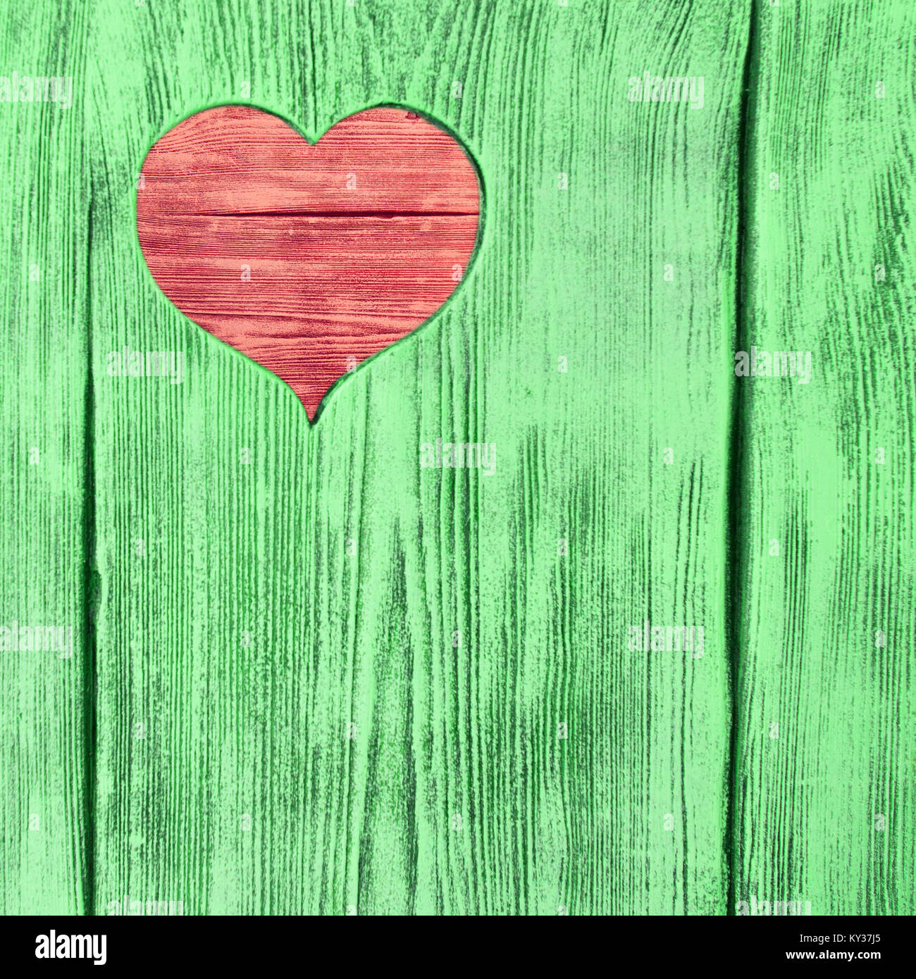 Red heart carved in a green wooden board. Background Stock Photo - Alamy