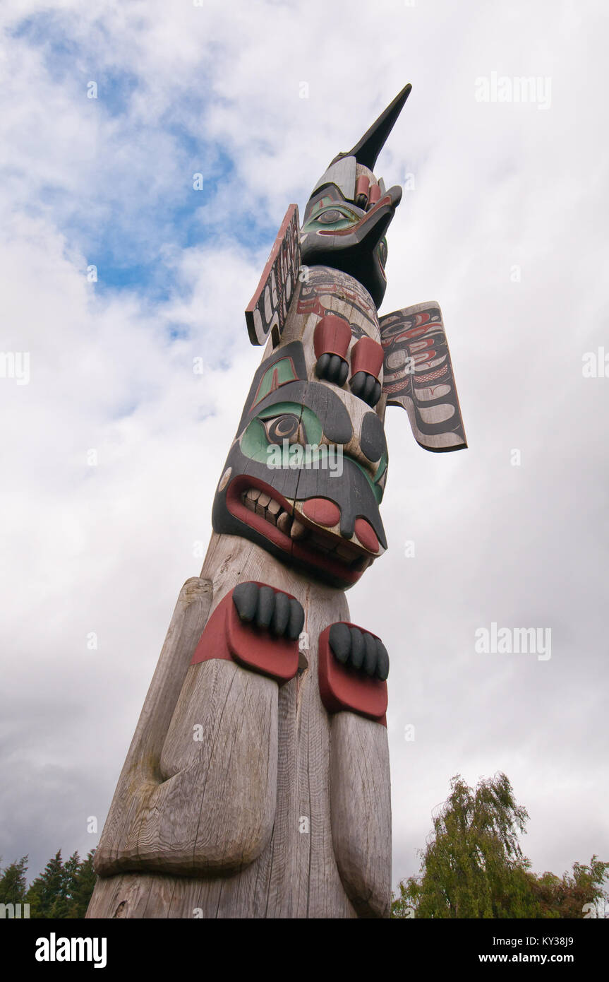 Tall towering totem pole built by the aborigines in Alaska Stock Photo ...