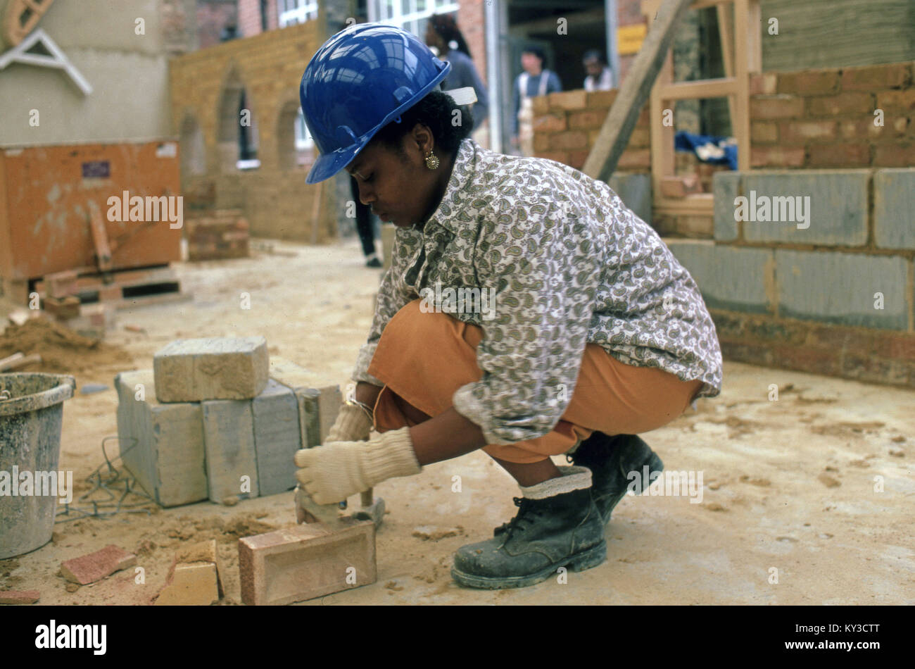 Woman learning to be a brick builder Stock Photo