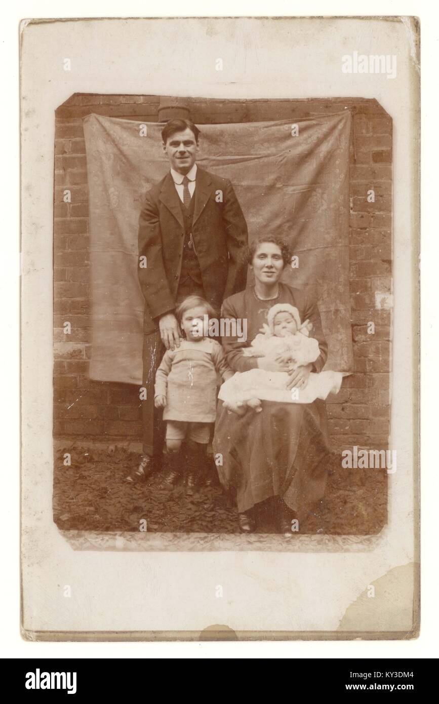 Original postcard portrait of family with small children, outside in front of canvas, circa 1912, U.K. Stock Photo