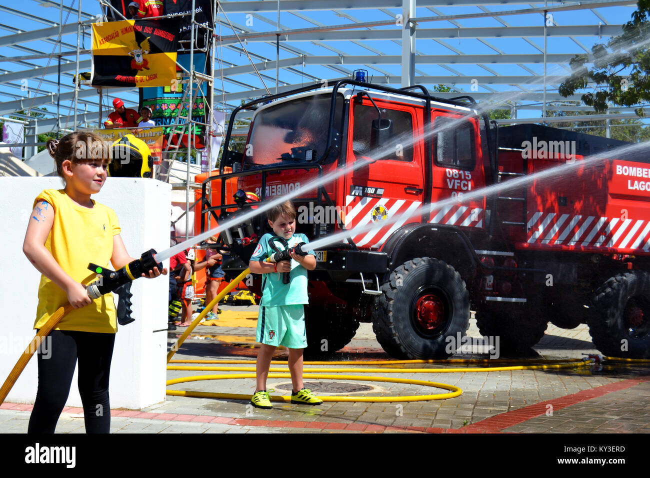 Portugal, Algarve, Lagoa, Circa 04.06.2017 Children learning how to be firefighters using fire hoses at a local international fair in Portugal. Stock Photo