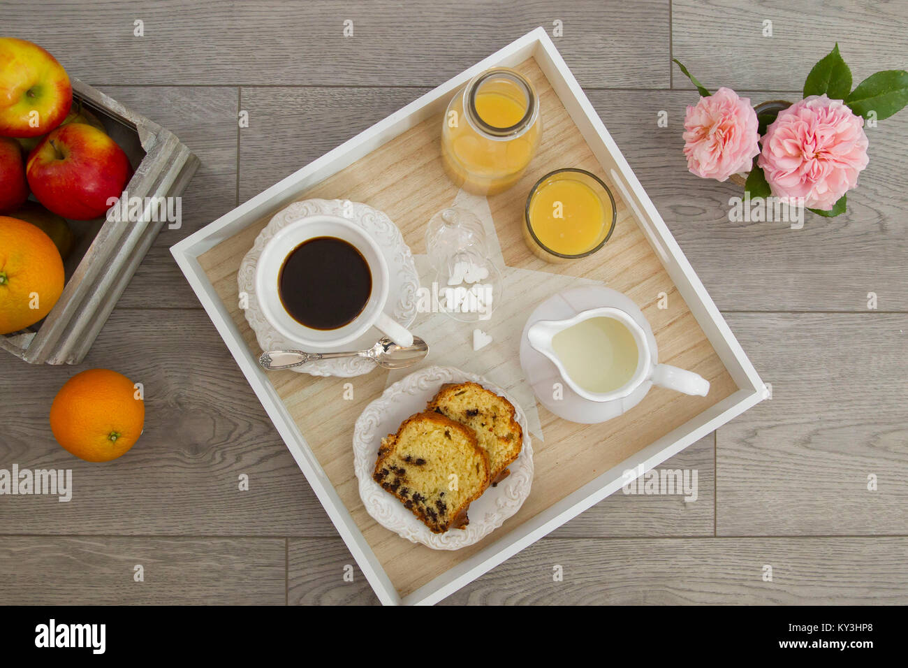 Breakfast seen from above, coffee, orange juice, milk, fruits and cake Stock Photo