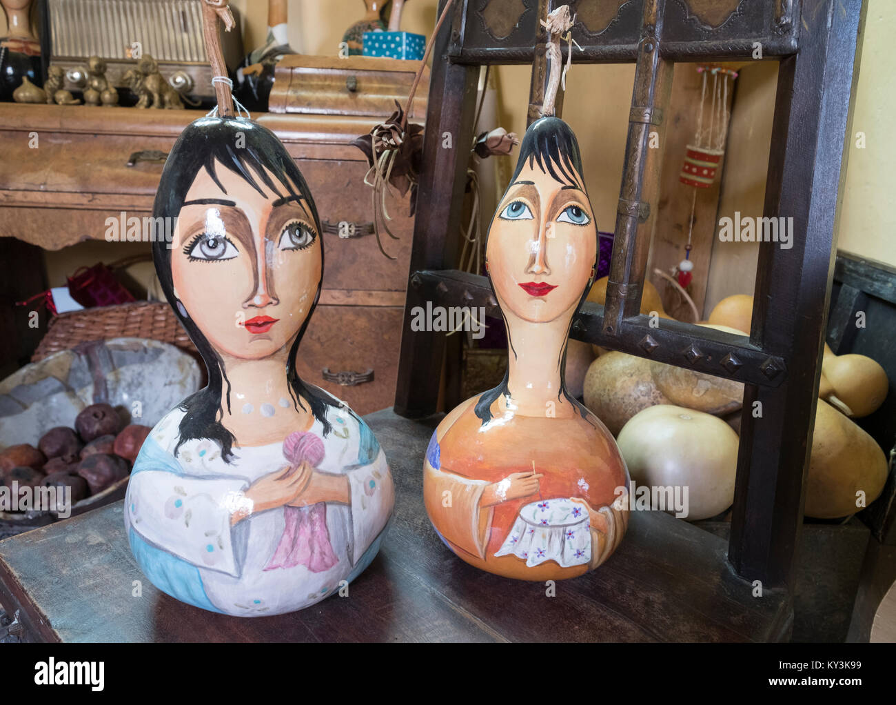 Painted faces on pumpkins and other art works in a small souvenir shop in Paphos old town centre. Stock Photo