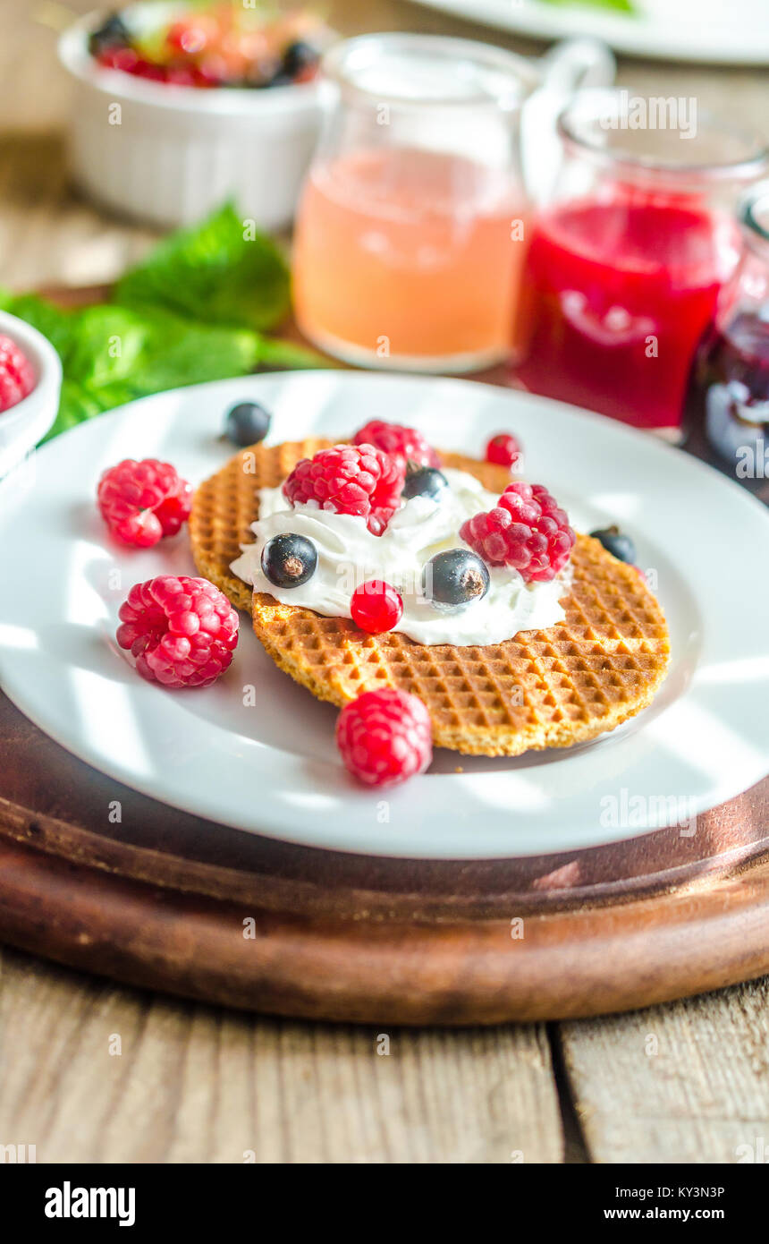 Belgian waffles with whipped cream and fresh berries Stock Photo - Alamy